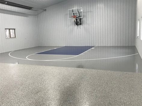 These Buffalo MN homeowners wanted the best of both worlds; a basketball court and a durable floor for storage in their pole barn. So we gave them both! The storage area is an All Chip floor coating in Gravel, and the basketball court is a solid color floor coating in gray with a blue key. Basketball Court In Garage, Shed With Basketball Court, Shop With Basketball Court, Pole Barn Basketball Court, Barn Basketball Court, Diy Basketball Court, Bball Court, Barn Gym, School Building Plans