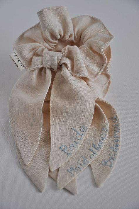 Linen scrunchies with long bows are sustainable hair accessories with hand embroidery or without it. They are perfect for finishing and styling hair in a ponytail or messy bun. It’s a great wedding hair accessory: bride accessories, bridesmaid accessory, bachelor party accessory,... Click through to see other colors or find other hair accessories! #weddingaccessories #brideaccessories #embroideredhairaccessories #hairaccessories #scrunchies #scrunchieshairstyles #girlstyle #hairstyles Schruncies Aesthetic, Embroidery Scrunchie, Wedding Scrunchie, Linen Accessories, Lace Hair Accessories, Heirloom Wedding, Girl With Brown Hair, Bridemaids Gifts, Styling Hair