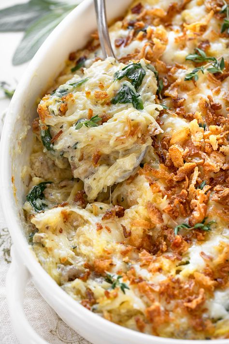 Brimming with fall flavors, this spaghetti squash casserole is prepared with a creamy Gruyere sauce and topped with crispy fried onions! | thecozyapron.com #spaghettisquashcasserole #spaghettisquashcasserolerecipes #spaghettisquashcasserolehealthy Thanksgiving Spaghetti Squash Recipes, Spaghetti Squash With Sausage And Spinach, Fall Squash Casserole, Spaghetti Squash Thanksgiving, Thanksgiving Spaghetti Squash, Spaghetti Squash Carbonara Recipes, French Onion Spaghetti Squash, Spaghetti Squash Turkey Recipes, Veggie Casserole Recipes Thanksgiving