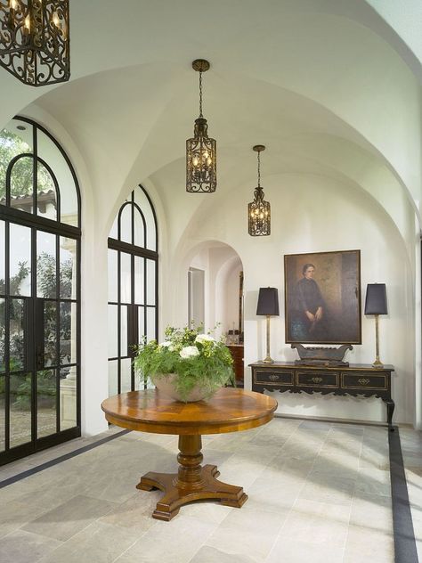 Style of the doors and lovely lighting creates a cool Mediterranean vibe [Design: Summerour Architects] Mediterranean Entryway, Steel Doors And Windows, Christmas House Lights, Crown Crystal, Farmhouse Side Table, Foyer Entryway, Casas Coloniales, Entry Way Design, Geometric Chandelier