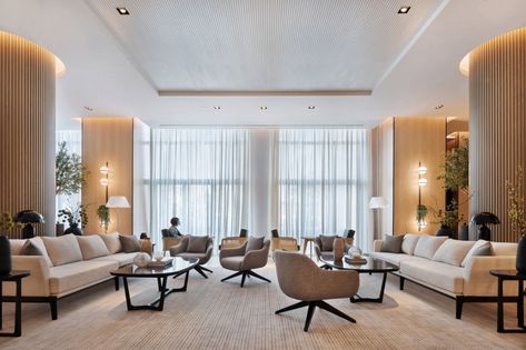 Hotel design, Lulie Fisher Design Studio, Vida Hotel, Dubai Hotel Lounge Area, White Marble Bar, Interior Design Studios, Emirates Hills, Pastel Furniture, Hotel In Dubai, Hidden Lighting, Communal Table, Lobby Lounge