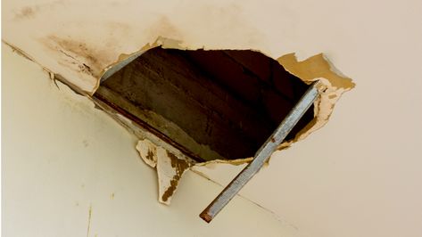 huge hole in the roof from rainwater | A Beginner's Guide To Ceiling Repair | ceiling drywall repair Repair Hole In Ceiling Drywall, Drywall Repair Ceiling, Repair Drywall Hole, Water Damaged Ceiling, Repair Ceilings, Drop Ceiling Panels, Sheetrock Repair, Ceiling Leak, Ceiling Repair