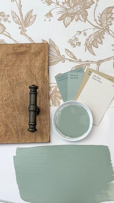 Sherwin Williams's Halcyon Green is a subdued, versatile green that blends calming blue undertones with a hint of gray.  Halcyon Green bridges the gap between a nature-inspired green and a more stately, traditional blue, making it a unique choice for those looking to introduce a refined yet down-to-earth color in their decor.  The color can vary in appearance throughout the day, skewing greener in bright sunlight and revealing more of its blue-gray character in the evening or in spaces with less natural light.   It pairs beautifully with light, sandy neutrals for a beachy, relaxed vibe, or with darker wood finishes for a more grounded and traditional atmosphere. Light Grey And Green Bathroom, Halcyon Green Sherwin Williams Cabinets, Living Room Paint Color Ideas Green, Sherwin Williams Blue Green Paint Colors, Halycon Green, Halcyon Green Sherwin Williams, Green Paint Sherwin Williams, Sw Halcyon Green, Sherwin Williams Sage Green