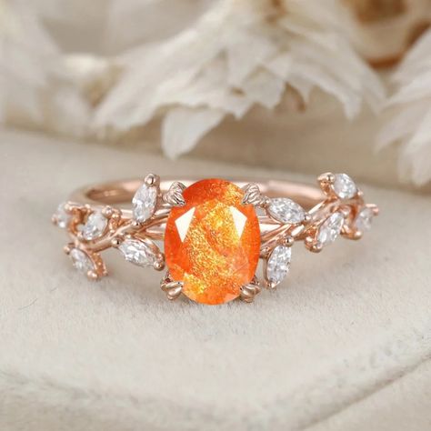 Our Handcrafted Oval Cut Sunstone Engagement Ring features a Nature-Inspired Branch Cluster in Solid Gold. The oval-cut sunstone and the cluster design create a ring that is both artistic and romantically inspired by the beauty of the natural world." Sunstone Ring Engagement, Orange Engagement Ring, Sunstone Engagement Ring, Sunstone Ring, Orange Ring, Cluster Design, Cute Engagement Rings, Couple Wedding Rings, Colored Engagement Rings