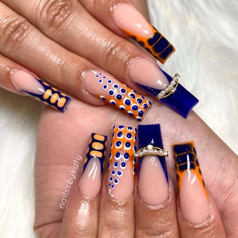 Funky nails: blue and orange french tip nails with croc print and dot patterns, nail charm on middle finger Blue N Orange Nails, Blue Orange And White Nails, Dark Blue And Orange Nails, Orange Croc Nails, Navy Blue And Orange Nails, Orange And Blue Nails Design, Navy And Orange Nails, Blue And Orange Nails Designs, Orange Blue Nails