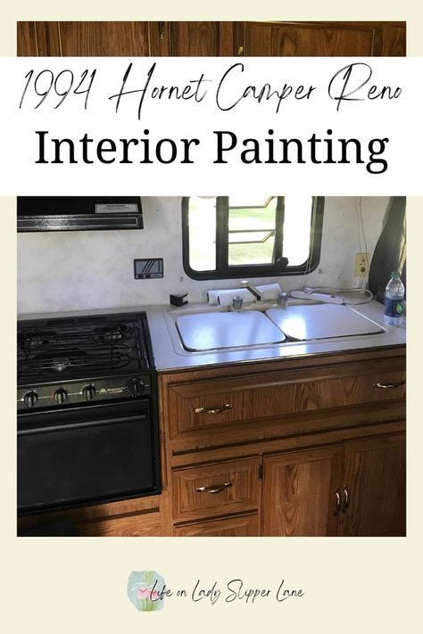 wooden camper cabinets with covered sink and black stove/oven Camper Renovation Interior, Camper Redo Ideas, Camper Renovation On A Budget, Camper Remodel On A Budget, Diy Camper Renovation, Remodel Camper, Camper Redo, Camper Reno, Old Campers