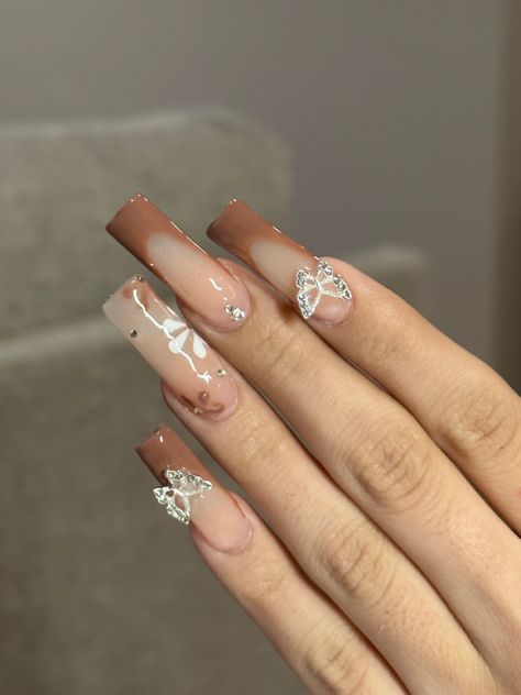 @ xnailsbyariana on instagram #brownnails #fallnails #butterflynails #blingnails #brownfrenchtip #flowernails #longnails #acrylicnails #acrylicnailssquare #squarenails brown nails, brown nail inspo, fall nails, fall nail inspo, butterfly nails, butterfly nail inspo, brown french tip nails, flower nails, flower nail inspo, long acrylic nails, square acrylic nails Brown Nails With Butterflies, Fall Nails Inspo Square, Tan Nails Acrylic Design, Pretty Nails Brown, Brown Hoco Nails, Prom Nails Brown, Brown Spring Nails, Fall Tapered Square Nails, Cute Fall Gel Nails