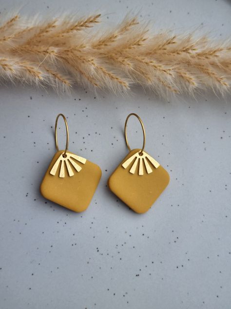 Beautifully unique rounded square ochre polymer clay earrings with a gold coloured fan charm on a gold plated hoop. These fun little fashion accessories are: ❤ handmade and one of a kind, therefore no two will ever be exactly the same ❤ made from super lightweight polymer clay so you can wear them all day - they are so comfortable, you will likely forget you have them on! ❤ finished with hypoallergenic gold plated hoops  The earrings are lovingly handcrafted by me and I take pride in making every set as beautiful as possible, however, due to their handmade nature, there may be slight variations compared to the picture and there may be minor imperfections in each piece. ORDER INFORMATION - your item will be: ★ dispatched within 1-3 business days ★ posted using Royal Mail  ★ beautifully and Gold Round Polymer Clay Earrings, Handmade Gold Hoop Earrings With Polymer Clay, Polymer Clay Earrings With Gold Findings, Bohemian Polymer Clay Earrings As Gift, Gold Clay Drop Earrings Jewelry, Everyday Bohemian Polymer Clay Earrings, Gold Leaf Polymer Clay Earrings, Hoop Earrings With Charm, Earring Clay