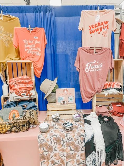 T-shirt Booth Display Ideas, Tee Shirt Booth Display, How To Set Up A Shirt Booth, Shirt Market Display, Shirt Craft Fair Display, Vendor Tablecloth Ideas, Sales Booth Display Ideas, Clothes Display Ideas Booth, Festival Booths Ideas