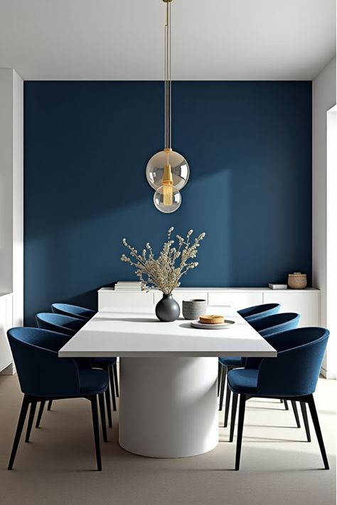 Modern dining room with navy blue accent wall and white furniture Blue Accent Wall Dining Room, Navy Blue Accent Wall, Paint Dining Room, Blue Accent Wall, Dining Room Navy, Setting The Mood, Dining Room Paint Colors, Paint Trends, Blue Accent Walls