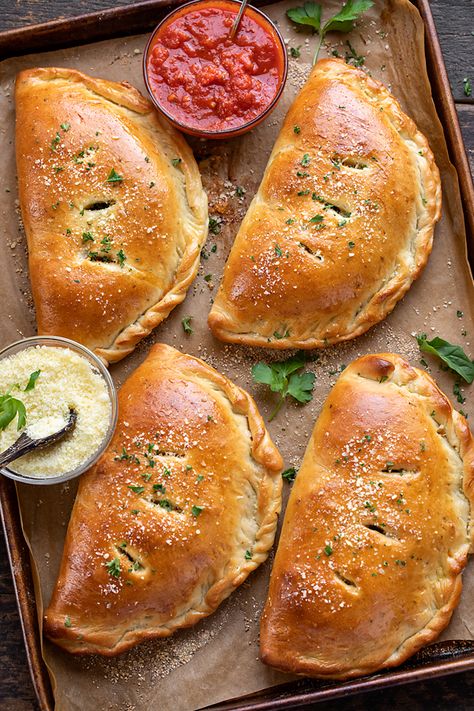 This calzone recipe is prepared with homemade calzone dough and a savory filling of ricotta, mozzarella, mushrooms and garlicky spinach! | thecozyapron.com #calzonerecipe #calzone #calzones #calzonerecipeeasy #calzonerecipedough #calzonedough Calzone Filling Ideas, Calzone Recipe With Pizza Dough, Calzone Dough Recipe, Spinach Calzone Recipe, Mozzarella Mushrooms, Easy Calzone, Italian Calzone, Calzone Dough, Calzone Recipe Easy