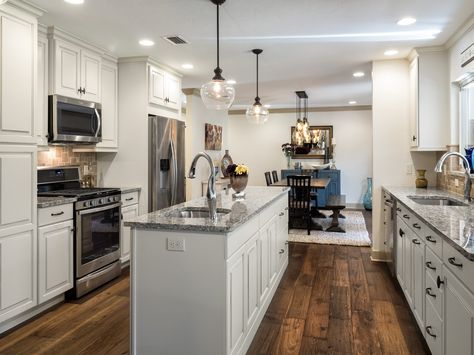 Galley Kitchen with Island, Drop Pendants, Wood Floors, Cream Colored Cabinets, Granite Counters, Stainless Steel Appliances Double Galley Kitchen Layout, Wide Galley Kitchen, Galley Kitchen With Island, Cream Colored Cabinets, Colored Cabinets, Kitchen Galley, Galley Kitchen Layout, Kitchen Layouts With Island, Island Storage