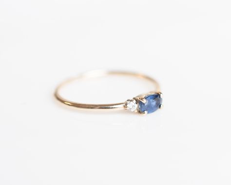 A deep blue sapphire paired with two radiating white diamonds, the Blue Sapphire Ring is captivating with it's brilliance and beauty. Delicately balanced with two light-catching diamonds, the center sapphire is a symbol of sincerity, virtue and good fortune that also embodies elegance. - 14k solid gold - 2 x 1.7mm round white diamonds - 5 x 3mm blue sapphire - Enjoy 30-day returns Quality: Our diamonds average SI or better so can they sparkle and shine for years to come. Our jewelry is only made Halo Engagement Ring Wedding Band, Sapphire Wedding Rings, Engagement Rings Vintage Halo, Blue Sapphire Ring, Diamond Engagement Rings Vintage, Sparkle And Shine, Matching Rings, Blue Sapphire Rings, Art Deco Jewelry