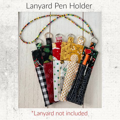 "Never lose your pen again! The Lanyard pen holder keeps your writing utensils secure and close at hand.   *Holds pens, pencils or skinny markers   *7\" long by 2\" wide   *Metal ring easily attaches to any lanyard This clever holder keeps your pen or pencil tethered to your lanyard, so you'll never have to waste time searching for a writing tool again. The slim design fits pens, pencils and skinny markers while taking up minimal space on your lanyard. The Lanyard pen holder is perfect for teach Pen Lanyard, Lose Your Pen, Sewing Sayings, Lanyard Diy, Pen Keychain, Lanyard Accessories, Pencil And Pen, Teachers Office, Diy Lanyard