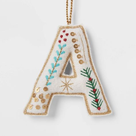 Hang an ornament on the tree for any family member's name with this Embroidered Fabric Monogram Letter Christmas Tree Ornament from Wondershop™. Made from wool and felt, this monogram ornament is designed as a letter of the alphabet in white with embroidered holiday accents. Designed with a top string loop, it's easy to hang from the branches of your tree. Welcome to the Wondershop™. Homemade Letter Ornaments, Family Name Ornaments Diy, Target Christmas Ornaments, Embroidered Christmas Ornaments Patterns, Initial Felt Ornaments, Machine Embroidered Christmas Ornaments, Felt Initial Ornament, Felt Embroidered Christmas Ornaments, Felt Letter Ornaments