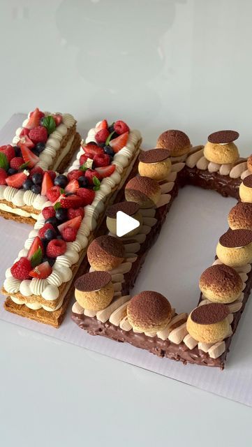 Fred Csibi-Levin | Doc Macaron on Instagram: "Number Cake and Petit Fours 🍓 🍫 🌰 - These delicious treats were made for a very special birthday celebrated on Bastille Day, watch until the end. 🇫🇷   A variety of techniques, doughs, creams, flavors and textures were applied, including puff pastry, a soft cake, choux, and chocolate tempering for the 100% edible Eiffel Tower stand.  Components of the number: - Vanilla bean and hazelnut cake, coated with a Rocher glaze - Whipped milk chocolate ganache  - Choux pastry with craquelin filled with hazelnut crème légère - Salted caramel - Puff pastry - Vanilla bean diplomat cream  - Mixed berries confit  - Fresh berries, mint leaves   Petit fours: macarons (raspberry, chocolate, passion fruit), choux puffs (caramel vanilla), blueberry tartlets Blueberry Tartlets, Macarons Raspberry, Chocolate Passion Fruit, Diplomat Cream, Chocolate Tempering, Choux Cream, Instagram Number, Soft Cake, Milk Chocolate Ganache