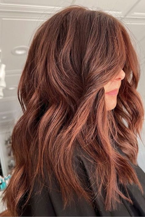 If you’re leaning towards reddish-brown tones, you’ll love this dark auburn color that is best paired with brunette hair. It will keep the tone natural but still enrich the warm look.//photocredit:@balayageby_mtlewis Reddish Golden Brown Hair, Muted Red Brown Hair, Reddish Brown Highlights, Long Reddish Brown Hair, Brown Copper, Light Radiant Auburn Hair, Warm Autumn Hair Color, Redish Brown Hair Color, Medium Reddish Brown