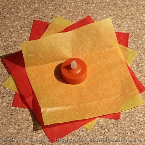 How to Build a Campfire | About Family Crafts Fire Out Of Tissue Paper, Diy Fire Craft, Fake Campfire Diy Tissue Paper, Tea Light Campfire, Diy Camp Fire Craft, Tissue Paper Campfire, Diy Camping Decorations Party Ideas, How To Make Fake Fire With Tissue Paper, Diy Fake Campfire With Lights