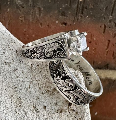 🪶 Birds of a feather flock together 🪶 📸 ℹ️ Material: Sterling Silver Engraving: Bright Cut w/ accent feathers Finish: Antiqued Center Stone 1 carat #jensensilver #customsilver #rodeofashion #engraved #westernfashion #westernwedding #rancher #cowboy #sterlingsilver #sterlingsilverring #scrollwork #brightcutengraving #westernweddingrings #ranchwife #ranchwedding #westernring #engravedengagementring #cubiczirconia #westernweddingmagazine #customdesign #cowboyfashion #handengraved #engrav... Western Wedding Rings Sets, Western Wedding Rings, Western Rings, Engraved Engagement Ring, Wedding Items, Rings Unique, Rodeo Fashion, Birds Of A Feather, Cowboy Style