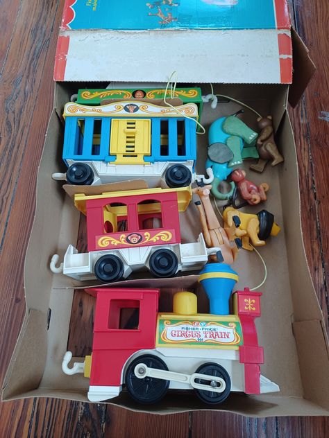 Vintage Fisher Price 1973 four car train set #991 with original box. It includes all four cars: two seat train engine with yellow push button that makes "toot toot" sound, green cage car with yellow top and yellow fold down door, blue flat car, two seat red caboose with a yellow top. Includes six animals:  lion, elephant, giraffe, bear and monkey. The people are not included.  The set and box are in really good condition--the giraffe is missing the end of his tail, there is a little dirt from storage but it looks like it was very carefully played with. 70s Toys Childhood Memories 1970s, 70s Toys Childhood Memories, 80s Flashback, Member Berries, Thrift Wishlist, 80s Childhood, Vintage Fisher Price Toys, Circus Train, Family Circus