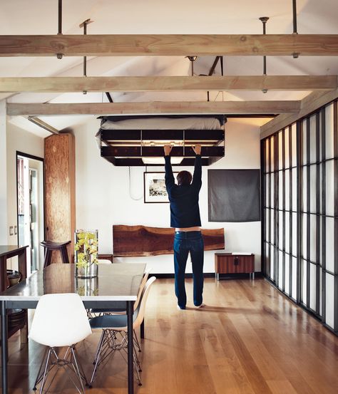 The bed pulls down from a nook in the ceiling--probably one of the most inventive, small-living tricks I've seen. Suspended Bed, Cabin Loft, Gift Towers, Murphy Bed Plans, Compact House, Tiny Apartments, Christmas Tradition, Space Interiors, Tiny Spaces