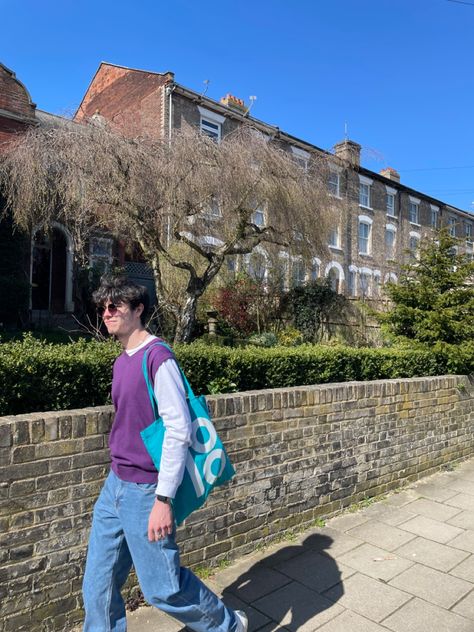 Person wearing blue baggy jeans with a purple sweater vest layered over a long sleeve white Shirt walking down the street. Purple Sweater Vest Outfit Men, Purple Vest Outfit, Knitted Vest Outfit, Purple Sweater Vest, Vest Outfits Men, Knit Vest Outfit, Guy Outfits, Green Sweater Vest, Jean Fits