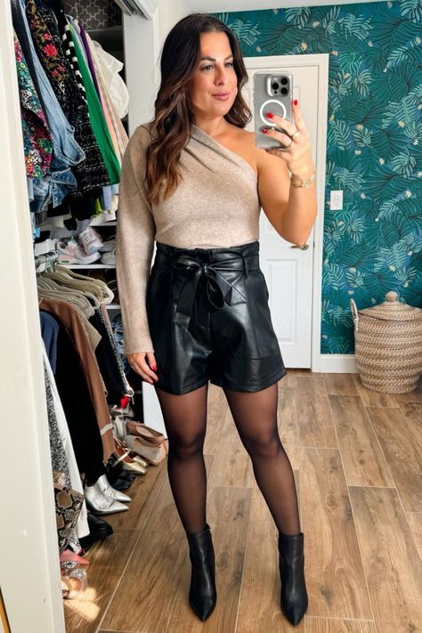 Looking for a cute office Christmas party outfit idea? Then you’re in luck because I’m sharing a casual yet super stylish ensemble that would be great for a work event. For this holiday look, simply pair a classy one-shoulder sweater with trendy faux leather shorts, ankle black boots, and bow tights for the perfect finishing touch. What do you think of this Amazon look? Holland Paterno. Office Christmas Party Outfit Leather Shorts Outfit Winter Party, Leather Shorts Holiday Outfit, How To Wear Leather Shorts In Winter, Shorts With Opaque Tights, Black Above-knee Shorts For Night Out, Christmas Party Outfit, Walmart Fashion, Christmas Party Outfits, Next Clothes