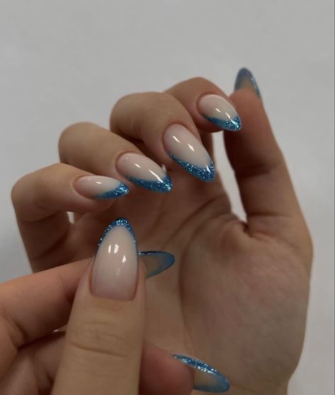 Nice Almond Nails, Blue Sparkle Tip Nails, Blue Sparkle Nails French, Nail Ideas Concert, Blue Sparkle Christmas Nails, Blue Sparkly Nails Almond, Blue Holiday Nails Acrylic, Saltburn Nails, Sparkly Blue French Tip Nails