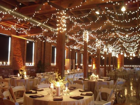 Indoor wedding with string lights - Decoist Wedding Ceiling Decorations, Fairy Lights Wedding, Wedding Reception Lighting, Wedding Ceiling, Barn Wedding Decorations, String Lights Wedding, Wedding Tablecloths, Inexpensive Wedding Venues, Xmas Lights