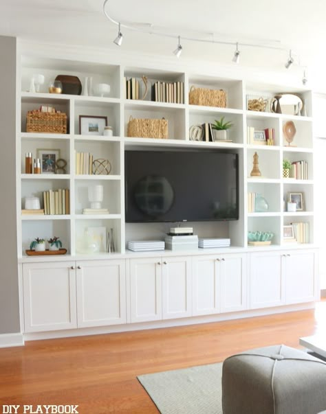 This white built-in entertainment center makes this room feel grand and inviting. Plus we love all of the storage and shelving to show off accessories. Tv Shelving, Chicago Condo, Ruang Tv, Built In Entertainment Center, Living Room Built Ins, Living Room Entertainment Center, Living Room Entertainment, Living Room Shelves, Room Shelves