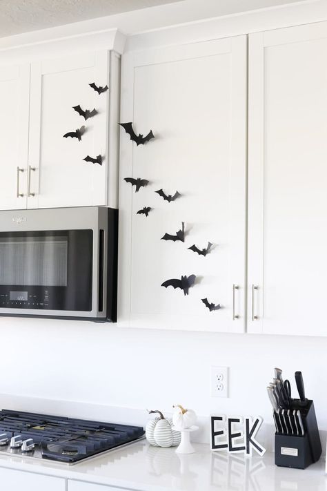 paper bats on kitchen cabinets in a white kitchen Paper Bats On Walls, Bats Halloween Decorations, Cheap Halloween Decor, Mirror Fireplace, Easy Halloween Decor, Paper Bats, Pumpkin Decorating Diy, Bat Display, Diy Pumpkins Crafts