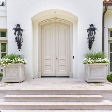 Breathtaking front door and entry to traditional style white stucco mansion in Buckhead. The 2020 Southeastern Designer Showhouse 'Villa Flora' is painted Benjamin Moore Seapearl and trim is Benjamin Moore Pashmina. #paintcolors #seapearl #benjaminmooreseapearl #pashmina #benjaminmoorepashmina #houseexteriors #housecolors White Stucco House, White Exterior Paint Colors, Benjamin Moore Exterior, White Exterior Paint, White Exterior Houses, Best White Paint, Stucco Homes, Neutral Paint Color, Stucco Exterior