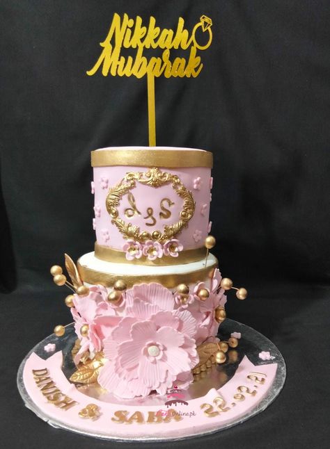 2 tiered Danish and Saba Nikkah Themed In shades of gold and pink, here's a nikkah bash🥳 cake for Danish & Saba! With pink handmade sugar paste flowers, it's an elegant design that befits the celebrations 💞 #nikkah #cake #flowers #topper #fondantart #chocolatelover @03466070181 https://cakeonline.pk/ Saba Name Cake, Dholki Cake Design, Kahula Cake, Nikkah Cake, Kek Kahwin 2 Tingkat, Customized Cake, Sugar Paste Flowers, Cake Flowers, Gold And Pink