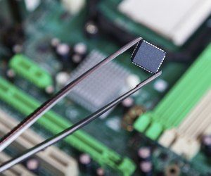 Where Is the ROM Chip Located in a Computer? | Techwalla.com Read Only Memory, Semiconductor Manufacturing, Memory Chip, Computer Chip, Tweezers, Motherboard, Storage Solutions, Chips, Computer