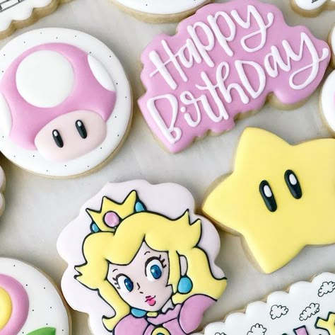 Lauren Wegner | Shreveport, LA Cookie Artist on Instagram: "Can you hear the music?🎵🎶 I used to play a lot of Super Mario as a kid, so this set had me feeling some serious nostalgia. 😄 I loved putting a girly spin on this classic video game. And of course we couldn’t leave out Princess Peach! My books are open for March and April! I also have limited availability for February 25. Message me for details! #princesspeachcookies #princesspeach #supermario #supermariocookies #birthdaycookies #numb Princess Peach And Bowser Cake, Princess Peach Food Ideas, Mario And Peach Party, Princess Peach Sugar Cookies, Girly Mario Birthday, Princess Peach Cookies Decorated, Super Mario Girl Birthday Party, Mario Birthday Party Girl, Girl Mario Birthday Party