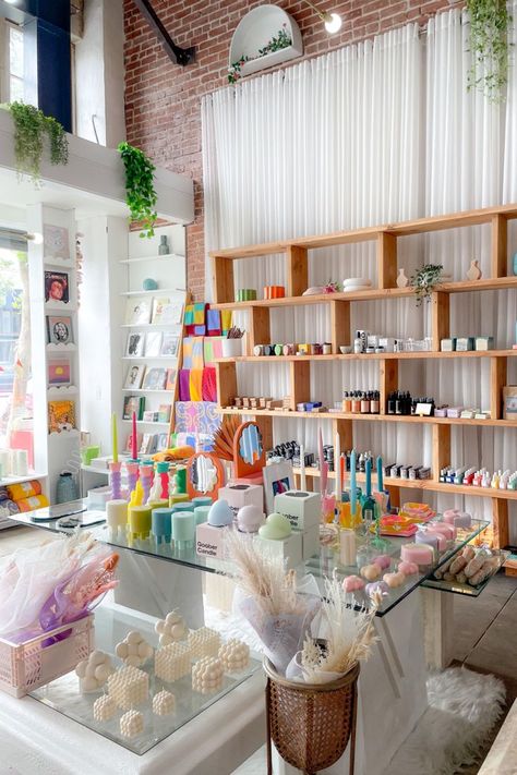 The interior of a boutique shop. In the foreground is a glass table with an assortment of candles of different shapes, sizes, and colors. Behind is a wall of shelves holding apothecary items, and to the left is a slim shelf holding books. Highland Park Los Angeles, Heal Your Soul, Christmas Posts, Ceramic Store, Hobby House, Salon Suites, Concept Shop, Candle Store, Ceramic Shop