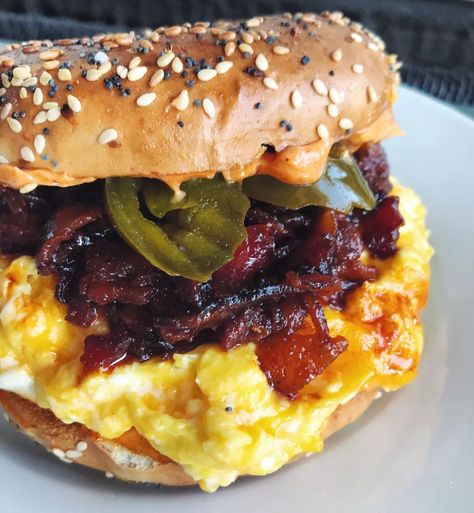 If you like sweet, savory and spicy sandwiches then this breakfast bagel sandwich is for you! Made with a sweet and smokey bacon jam, cheesy scrambled eggs, and spicy pickled jalapeños on a toasted everything bagel with a smear of smokey paprika aioli. Cheese Bagel Sandwich, Breakfast Egg Recipes, Bagel Sandwich Recipes, Spicy Sandwich, Bagel Breakfast Sandwich, Smoked Salmon Bagel, Salmon Bagel, Scrambled Eggs Recipe, Cheese Bagels