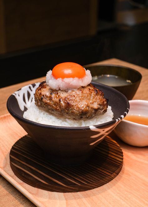 Tsukimi Hamburg Don - expect steaming rice, drizzled with bonito and kombu stock and topped with a thick Hamburg steak. Hamburg Steak Japanese, Japanese Diner, Japanese Hamburger Steak, Hamburg Steak, Japanese Food Photography, Sushi Go, Japanese Bakery, Japanese Steak, Japanese Beef