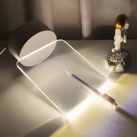 The LED Night Light Writing Board is a versatile and charming addition to any space. It serves as a note board, USB message board, and holiday light all in one. With its included pen, users can jot down reminders, messages, or doodles directly onto its surface. This makes it perfect for leaving sweet notes or important memos for loved ones. Its gentle illumination creates a cozy ambiance, making it an ideal night lamp for bedrooms or nurseries. #led #night #light #writing #writer #board #deli... Creative Kids Rooms, Note Board, Light Writing, Night Messages, Boutique Interior, Utila, Message Board, Night Light Diy, Night Lamps