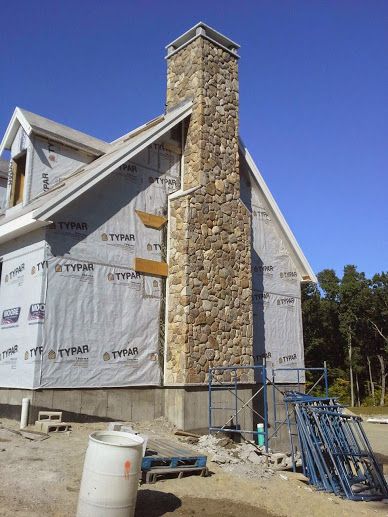 New England fieldstone chimney with granite cap stones River Rock Chimney Exterior, Cottage With Chimney, Stone Chimney Exterior, Cottage Chimney, Cottage Style Exterior, Chimney Ideas, Chimney Tops, Red Brick House Exterior, Chimney Caps