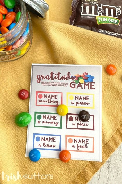 Give thanks for Thanksgiving and make those moments of grateful splendor a little sweeter with this free printable Gratitude Game. It's the perfect way to keep the kids occupied while waiting for dinner on Thanksgiving Day. #kenarry Skittles Gratitude Game, Grateful Party Ideas, Gratitude Activity Days Lds, M&m Gratitude Game, Gratitude Ice Breaker, M&m Thankful Game, Gratitude Game Free Printable, Gratitude Bracelet Diy, Thanksgiving Ministering Ideas