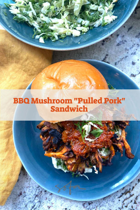 overhead shot of pulled mushrooms grilled and coated in harissa bbq sauce, on a fluffy burger bun with extra bbq sauce on top, and top of bun tilted off to side, with bowl of slaw in background. Vegan Pulled Pork Sandwich, Homemade Harissa, Bbq Mushrooms, Harissa Sauce, Vegan Pulled Pork, Mushroom Sandwich, Maitake Mushroom, Oyster Mushrooms, Pulled Pork Recipes