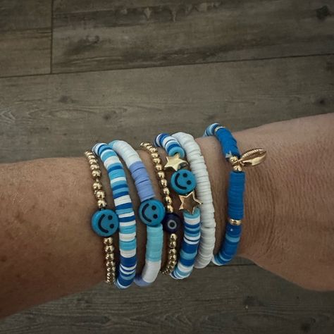 Homemade Stackable Bracelets. Smiley Face Friendship With Evil Eye And Shell. Blue And White Themed 2 Accent Gold Beaded Brackets As Well Set Of 7 - Can Stack In Any Order Or Rotate So Brad Isn’t Showing ** Custom Order Upon Request Check Out Other Listings For Bulk Shipping Blue Bracelet Ideas Clay Beads, Trendy Summer Bracelets 2023, Bead Brackets, Blue And White Clay Bead Bracelets, Flat Bracelet Ideas, Friendship Bracelets Flat Beads, Cousin Bracelets, Bead Bracelet Ideas Color Combinations, Clay Bracelet Stack