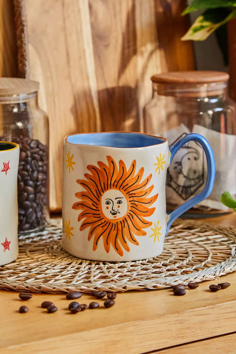 Complete your kitchen set with this celestial mug. Hand-crafted style Ft. a painted sun and stars design with a character face and a contrast handle. Pottery Painting Ideas Easy, Sun Mug, Pottery Sun, Painted Sun, Diy Mug Designs, Ceramic Dinner Set, Ceramic Cafe, Diy Pottery Painting, Character Face