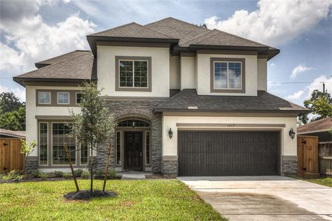 1519 CHANTILLY LN HOUSTON, TX 77018: Photo A beautiful stone and stucco facade is enhanced by lush landscaping and a new 8 foot privacy fence with gates on both sides. Light Stucco With Dark Trim, Stucco Siding Exterior Houses, Cream House Exterior Color Combos, Stucco Facade, Stone Skirt, Exterior Stucco, Stucco Colors, Dark Trim, Lush Landscaping