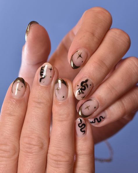 Make a statement with these stunning nails! We love the combination of black snakes and gold celestial accents. This mani was done by Tiffany and booked as Structured Soft Gel Mani with Nail Art 3+ Nails and one Additional Time block 🌙🐍✨ Book online or call us at 619.358.9876 to make an appointment. #nailart #gelnails #hellobirdie #hellobirdienails Eye Nail Art Black, Black And Gold Snake Nails, Nails With Snake Design, Snake Nail Art, Slay Nails, Snake Nails, Snake Nail, Old Money Nails, Harry Potter Nails