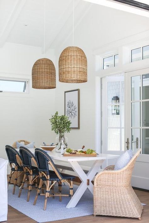 Blue rattan French bistro chairs at a white x base dining table on a blue lattice rug illuminated by a basket chandelier. Dining Room Remodel, Coastal Living Rooms, Wicker Chairs, Bistro Chairs, The Dining Room, Dining Room Inspiration, Room Remodeling, Dining Room Design, Beach House Decor