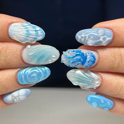 Short almond nails with an ocean theme. Includes a 3d hand sculpted jelly fish and blue chrome. Summer Nails Jellyfish, 3d Ocean Nails, Nail Ocean Designs, Water Looking Nails, Oceancore Nails, Shark Nails Art, Cute Ocean Nails, Under Water Nails, Water Theme Nails