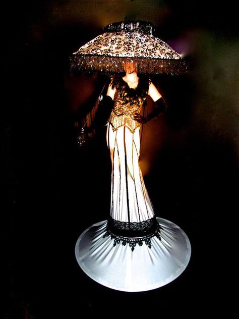 Illuminated Costumes and Strolling Human Tables Lamp Shade Costume, Lampshade Headpiece, Lamp And Moth Costume, Moth And Lamp Costume, Lampshade Costume, Lamp Halloween Costume, Drag Creature, Furniture Costume, Elaborate Halloween Costumes