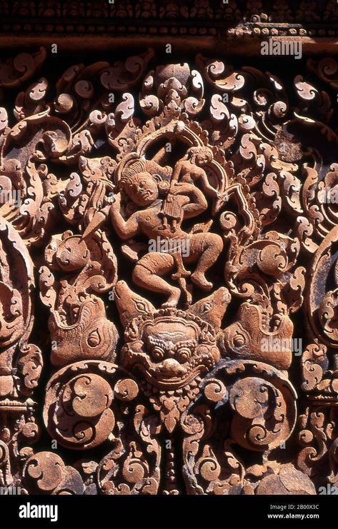 Download this stock image: Cambodia: Pediment detail, Banteay Srei (Citadel of the Women), near Angkor. Banteay Srei (or Banteay Srey) is a 10th century Cambodian temple dedicated to the Hindu god Shiva and is located to the north-east of the main group of temples at Angkor. Banteay Srei is built largely of red sandstone, a medium that lends itself to the elaborate decorative wall carvings which are still observable today. Banteay Srei is sometimes referred to as the jewel of Khmer art. - 2B00X Cambodian Temple, Khmer Art, Wall Carvings, Red Sandstone, God Shiva, The Hindu, The Jewel, Hindu God, Angkor